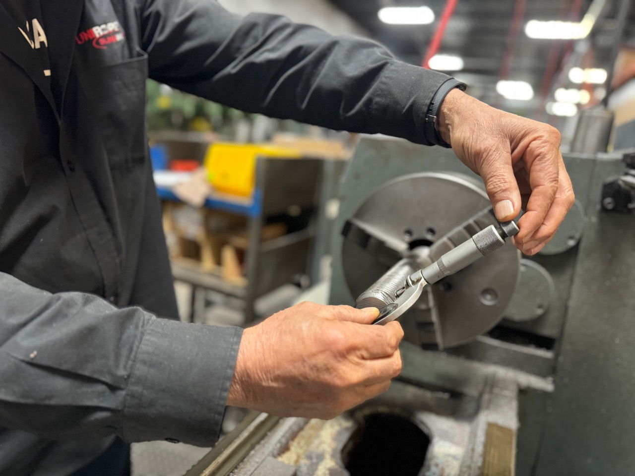 A Unirope technician verifies the thread dimension on a custom manufactured threaded stud that will be used to make a custom wire rope assembly.