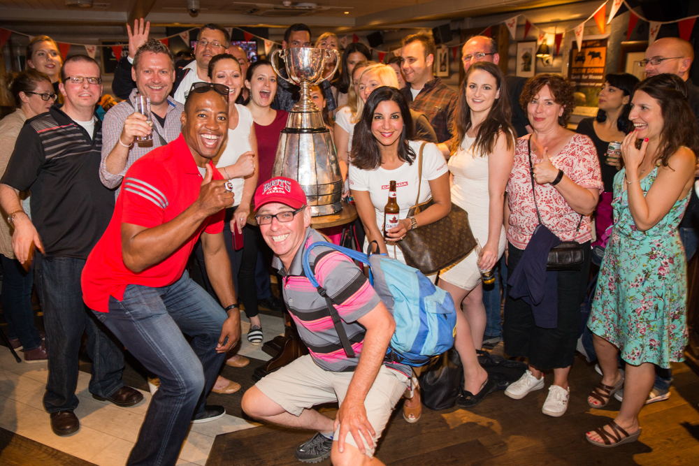Henry Burris poses with fans and the Grey Cup inside the Maple Leaf Sports Bar and Grill. Photo Credit: Jim Ross/CFL