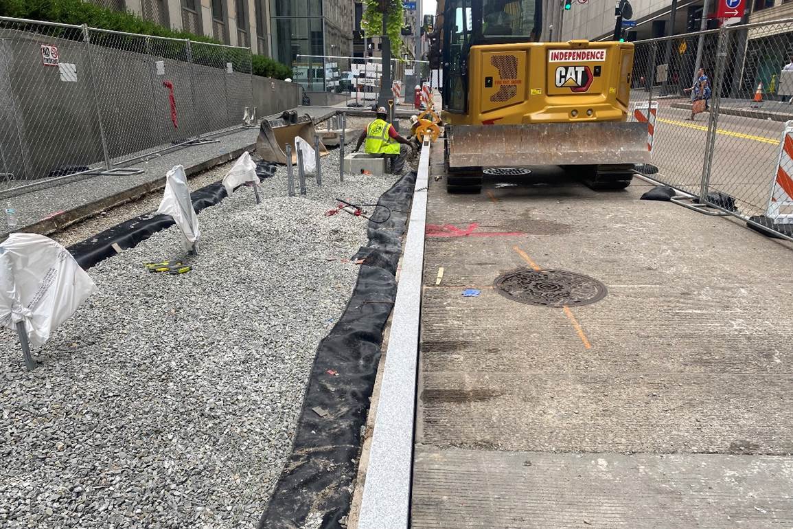 Granite curb being placed at Fifth Avenue and William Penn Place Granite curb being placed at Fifth Avenue and William Penn Place