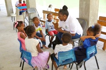 OECS Commission Staff reading to students as part of the USAID/OECS ELP 