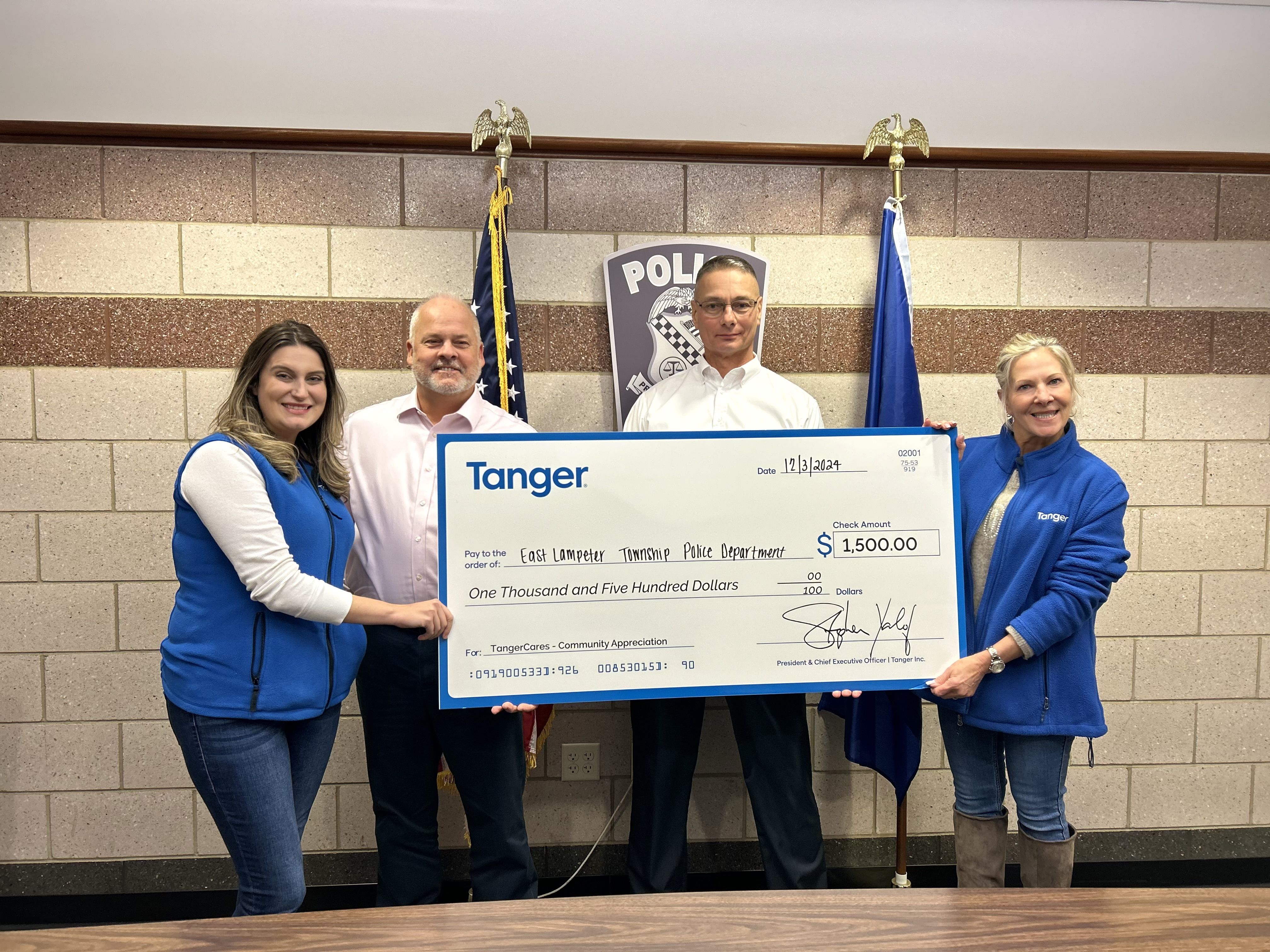 From left to right: Megan White, Area General Manager, Tanger Lancaster and Hershey; Chief Stephen Zerbe; Captain James Shank; and Monica Trego, Marketing Director, Tanger Lancaster, during the $1,500 check presentation at the East Lampeter Township Police Department on Dec. 3, 2024.