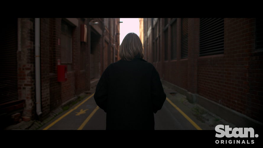 Kathryn Joy walks down alley