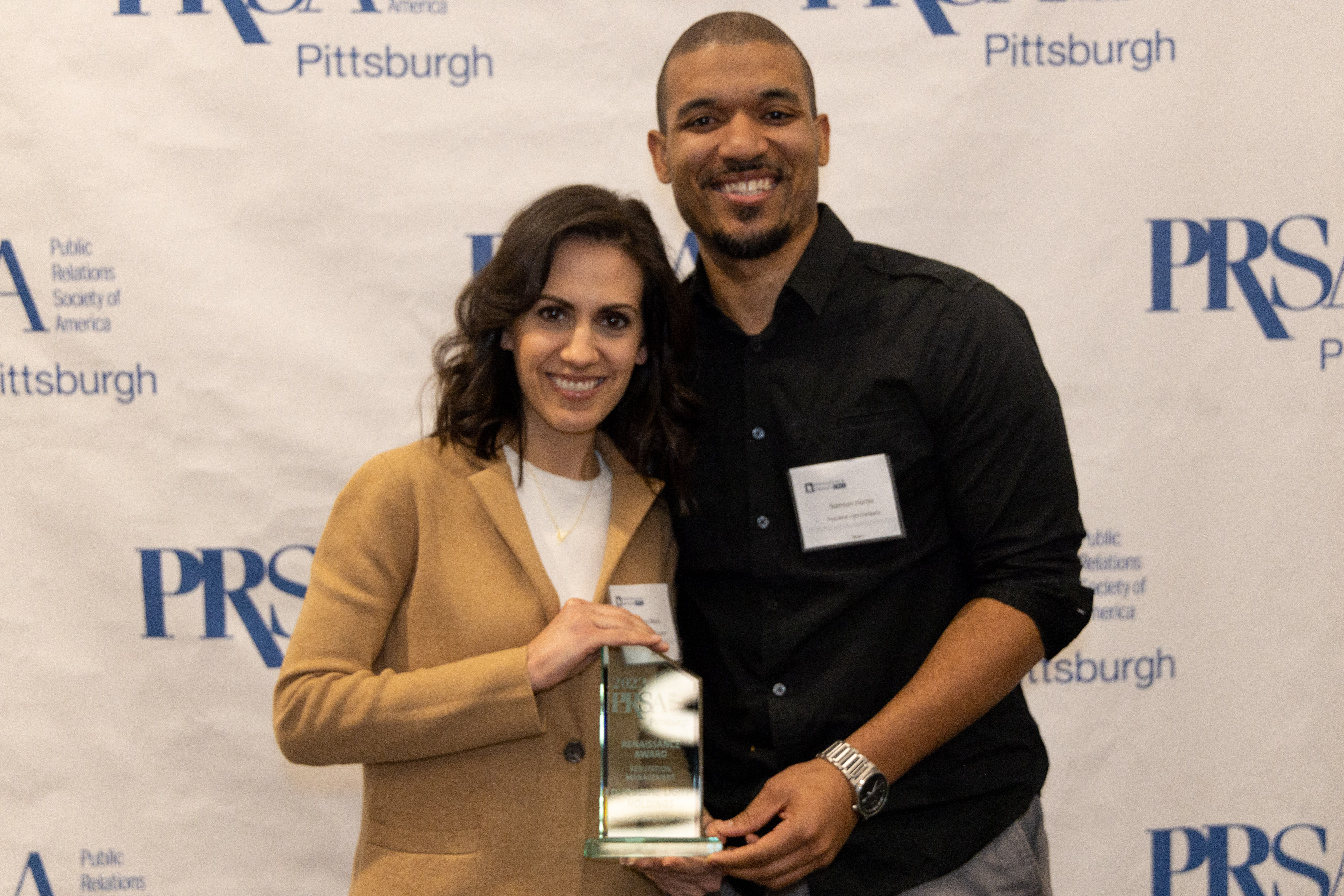 Duquesne Light Company's External Communications Manager Ashley Macik (left) and Associate Manager of Digital Media Samson Horne were part of the team that won "Best in Show" during the 2023 PRSA Pittsburgh Renaissance Awards at the Carnegie Science Center on Jan. 26.