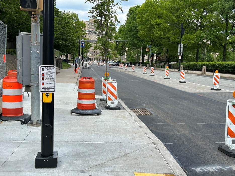 Newly installed tree, light, pedestrian safety signal, sidewalk, and roadway in Oakland Newly installed tree, light, pedestrian safety signal, sidewalk, and roadway in Oakland