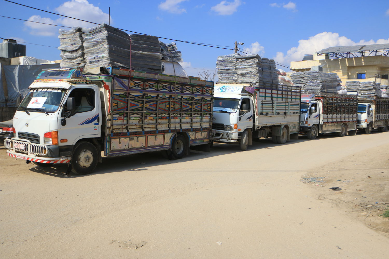 Title: MSF response to the earthquakes through Atmeh Hospital Copyright: Abdul Majeed Al Qareh Countries: Syria Date taken / Date Recorded: 11 February, 2023 Caption / Description: Trucks chartered by MSF teams from Atmeh hospital, on their way to a distribution, February 11, 2023.