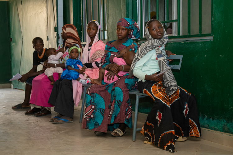 These women, who have come from the outskirts of Niono with their children for a free consultation, are waiting to see the doctor at the Community Health Centre. Venues de la périphérie de Niono avec leurs enfants pour bénéficier d’une consultation gratuite, ces femmes attendent de voir le médecin au Centre de santé communautaire. Copyright: Mohamed Dayfour Diawara These women, who have come from the outskirts of Niono with their children for a free consultation, are waiting to see the doctor at the Community Health Centre. Venues de la périphérie de Niono avec leurs enfants pour bénéficier d’une consultation gratuite, ces femmes attendent de voir le médecin au Centre de santé communautaire. Copyright: Mohamed Dayfour Diawara