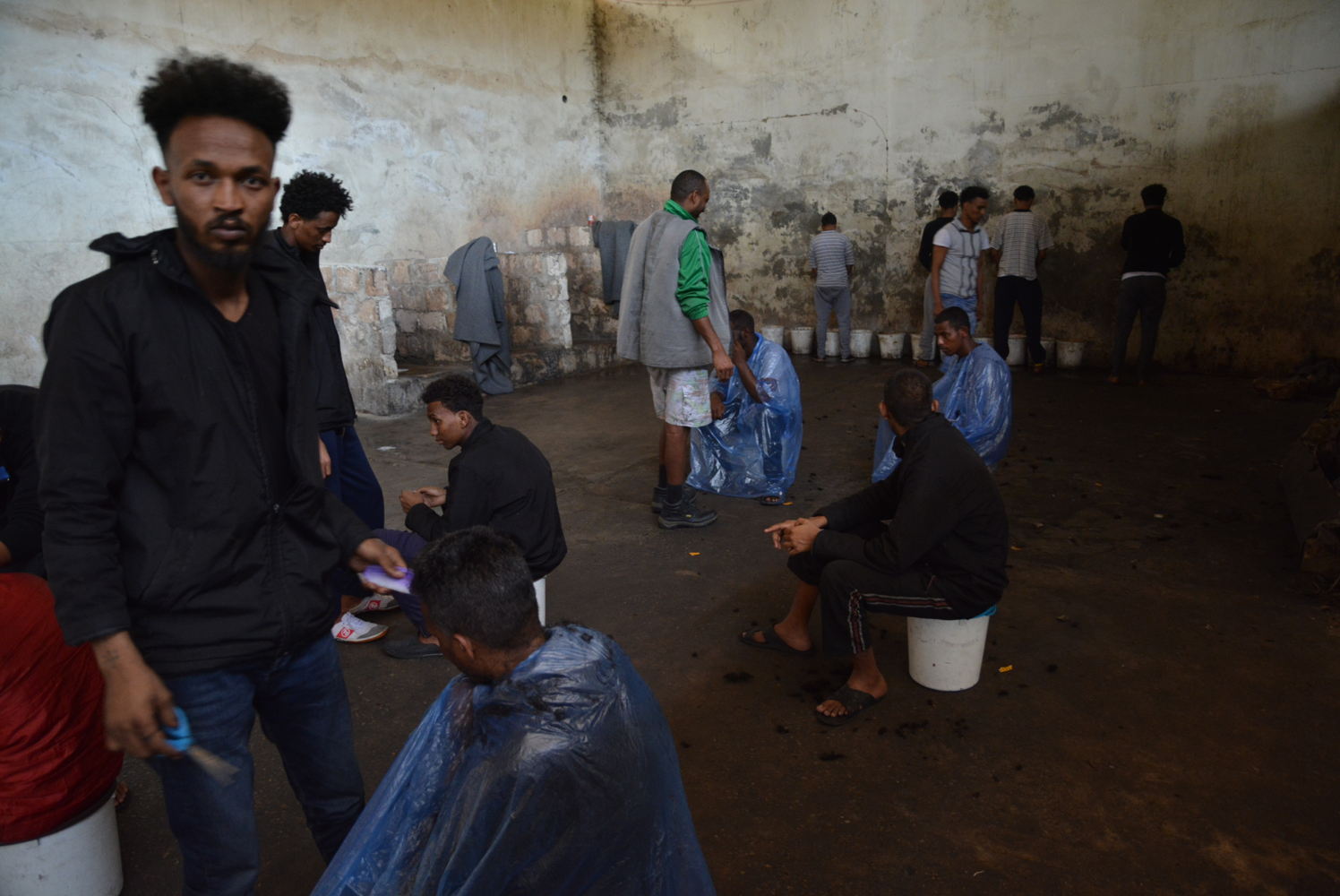 3) Sanitation conditions in the agricultural warehouse were shocking. The 700 inmates had four barely functioning toilets, buckets to urinate in, no shower and only sporadic access to water, which was unsuitable for drinking.  

A tuberculosis outbreak had likely been raging through the detention centre for several months. © Jérôme Tubiana/MSF