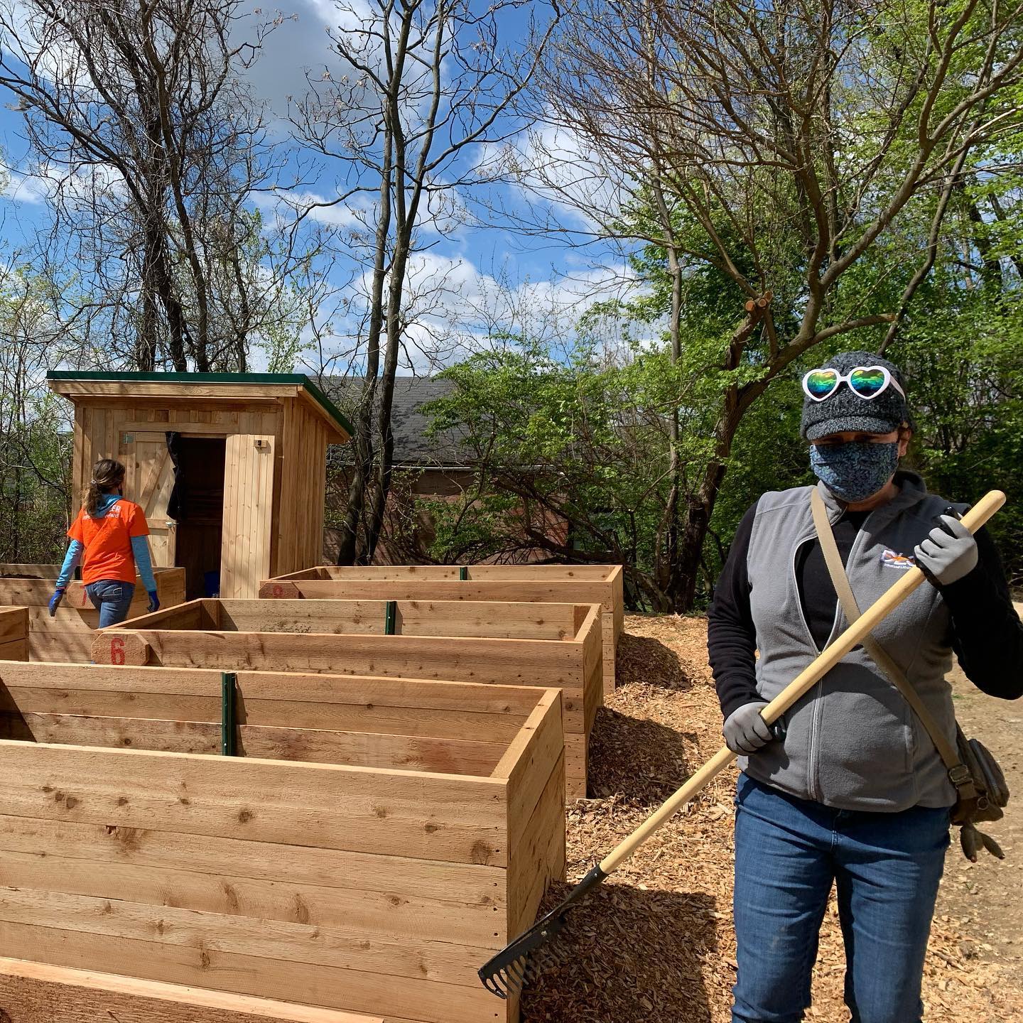 DLC volunteers lay woodchips near large planter boxes at Sunny's Community Garden in Pittsburgh's Hill District neighborhood. (Repair the World Pittsburgh)