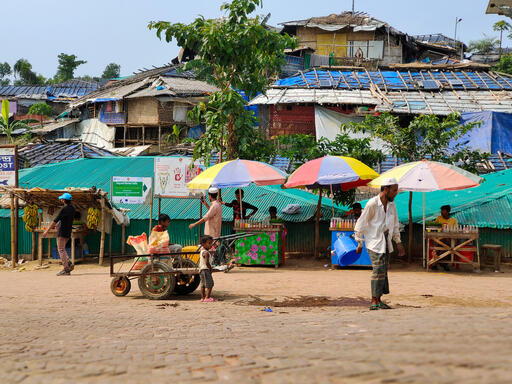 Rohingya refugees walk down a street in the camp, which they are not allowed to leave. Cox’s Bazar, Bangladesh, October 2023 © Ro Yassin Abdumonab