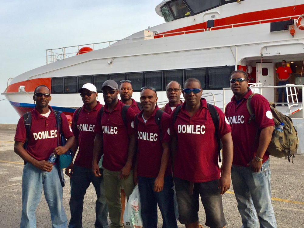 A team from Dominican Electricity Services arrive back home after helping in Anguilla
