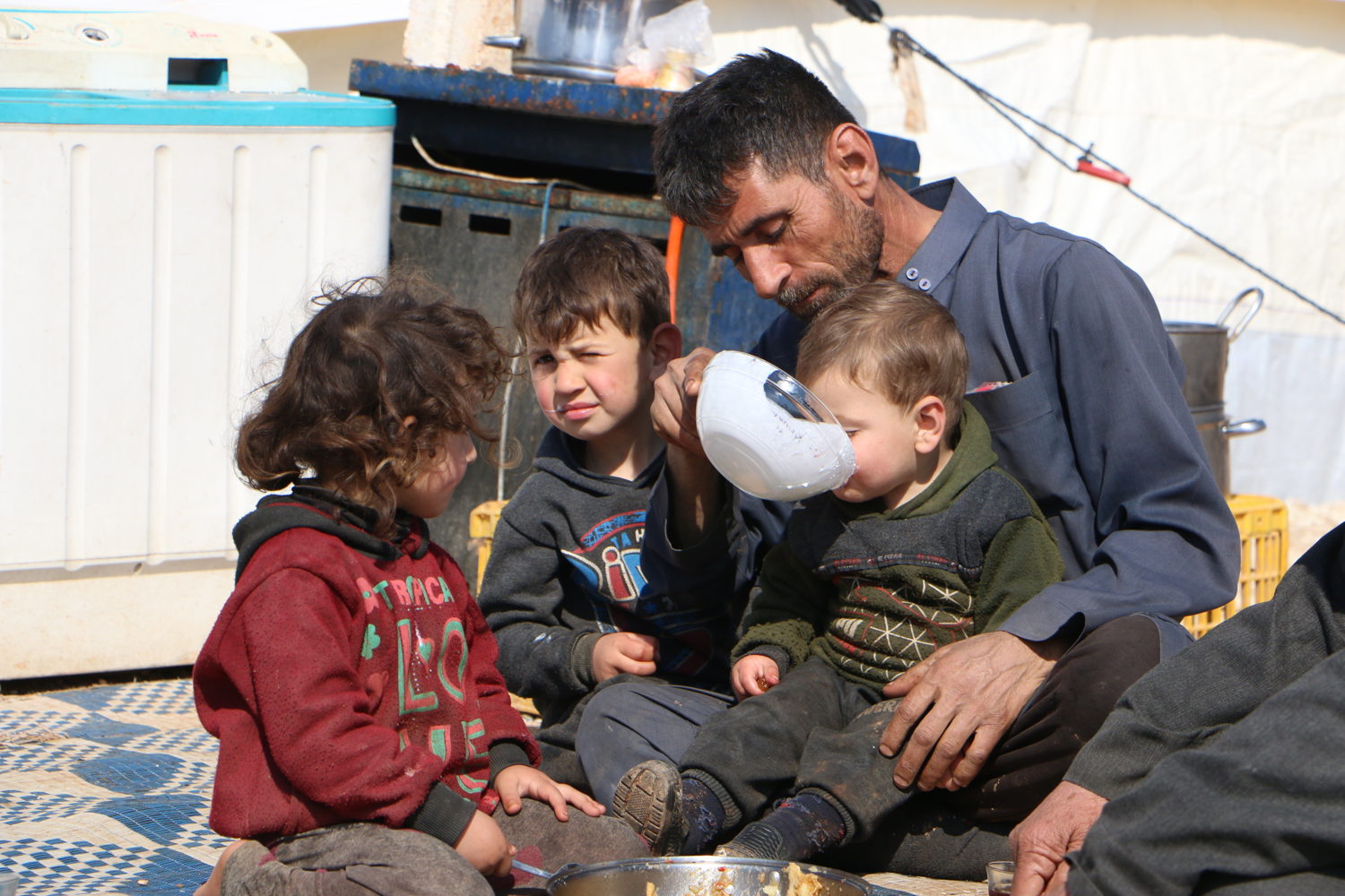 A family of displaced people in front of their tent, in Deir Hassan camp.

The primary healthcare centre supported by MSF in Takad (Western Aleppo countryside) had to be moved mid-February to a safe place when the frontline got close. It is now in Deir Hassan camps which are overcrowded with 120 000 displacled people and where basic services are insufficient.
In Deir Hassan settlements, living conditions are dire as there is a severe lack of basic services with the influx of IDPs.


As the offensive conducted by the Syrian governmental forces with their Russian allies intensified in Idlib province, 900 000 people have fled since 1 December, northwards and towards the Turkish border. Some could settle in existing camps, like Deir Hassan camps in Al-Dana district. Some settled in the neighbourhood of existing camps which are overcrowded, and others continued further north.