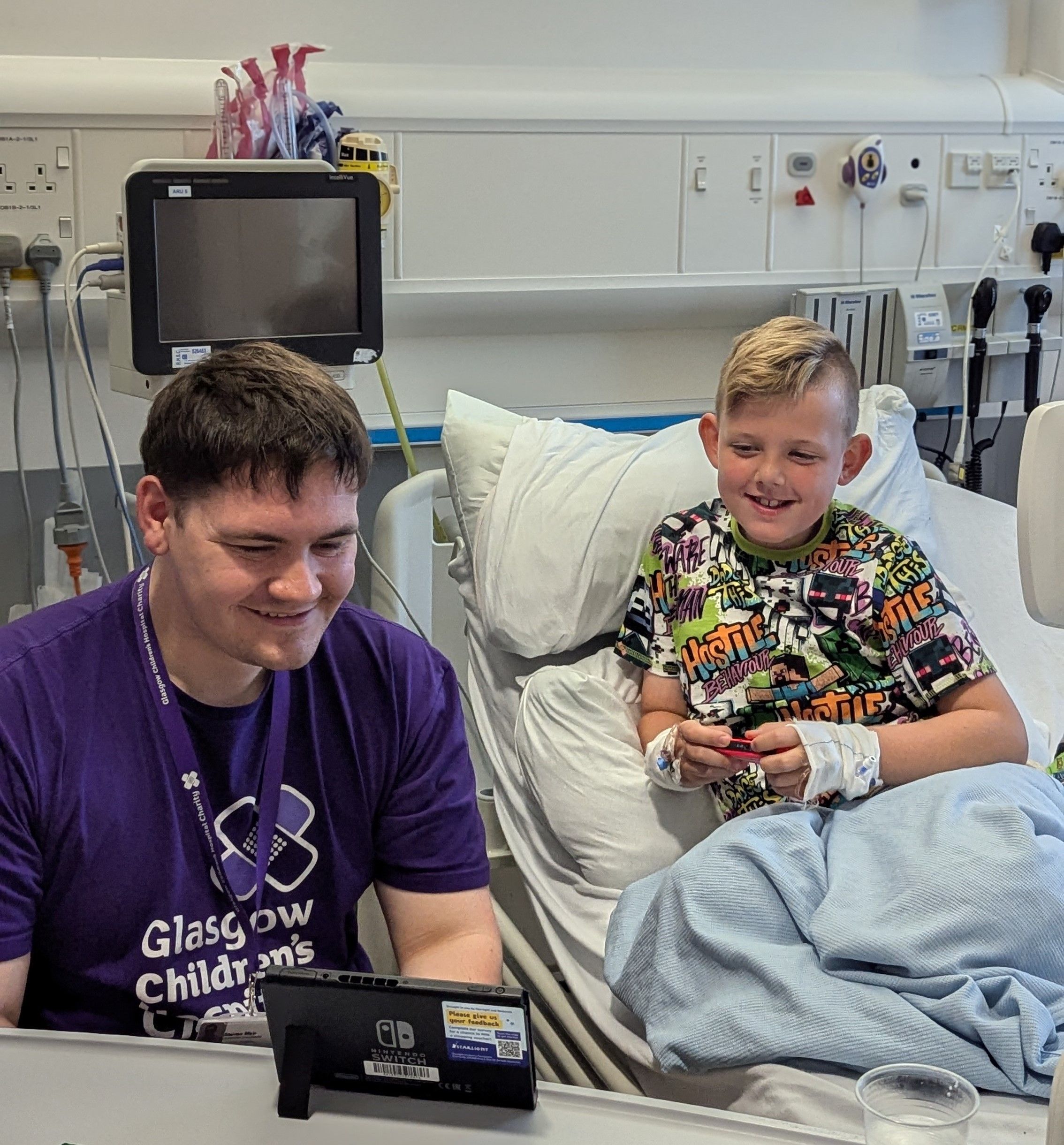 Gamer-in-Residence, Steven Mair (26) plays with eight-year-old patient Martin at the Royal Hospital for Children in Glasgow, Scotland. The Gamer-in-Residence role was fully funded by gamers in Scotland.