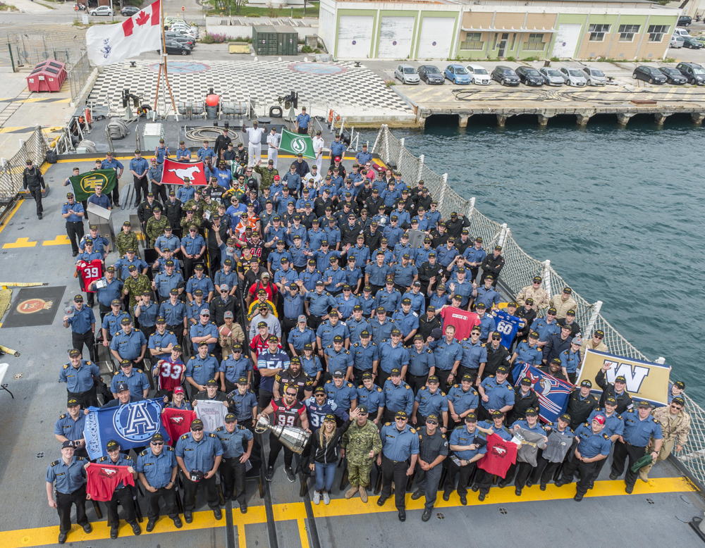 CFL players and members of the Canadian Forces aboard the H.M.C.S. St. John's in Marseille, France