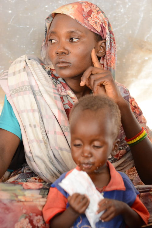 Hamad, 3 years old, sits with his mother in the ATFC at Zamzam Camp, North Darfur, while receiving treatment for severe malnutrition.Zamzam camp near El-Fasher | 30/08/2024 | Photographer: Mohammed Jamal.