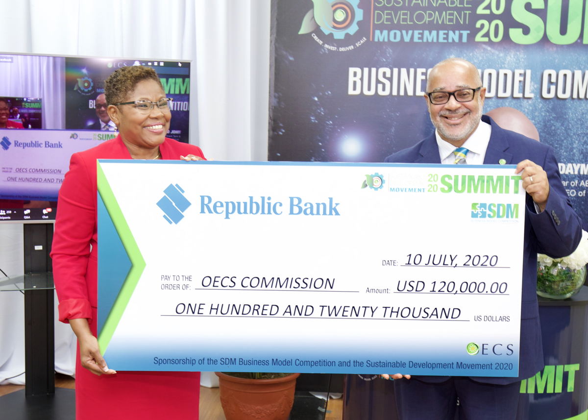 Managing Director of Republic Bank (EC) Limited, Michelle Palmer-Keizer, officially hands over the title sponsorship cheque to OECS Director General, Dr. Didacus Jules