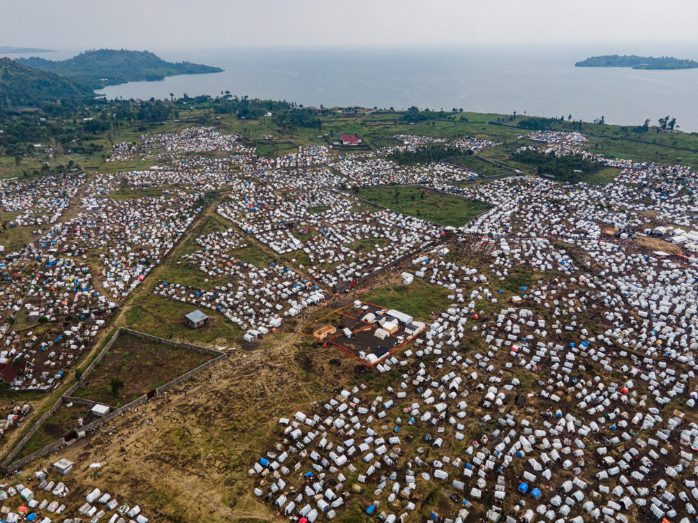 Title: Aerial view of the Bulengo IDP site Copyright: Michel Lunanga/MSF Countries: Democratic Republic of Congo Date taken / Date Recorded: 17 February, 2023 Caption / Description: Aerial view of the Bulengo IDP site on the outskirts of Goma city, North Kivu. MSF is providing free medical assistance and clean water to more than 7,000 households that have taken refuge there since 2023 following armed clashes in and around the Mweso health zone. The organization is also building 200 latrines, 120 of which are already functional