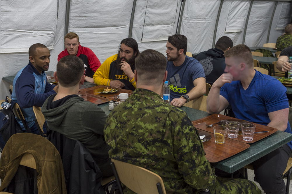 Matt Black (L), Andrew Buckley (C), and Mike Filer (R) in the mess talking to military members deployed on OP UNIFIER in Starychi, Ukraine. Photo: MCpl Mathieu Gaudreault, Canadian Forces Combat Camera