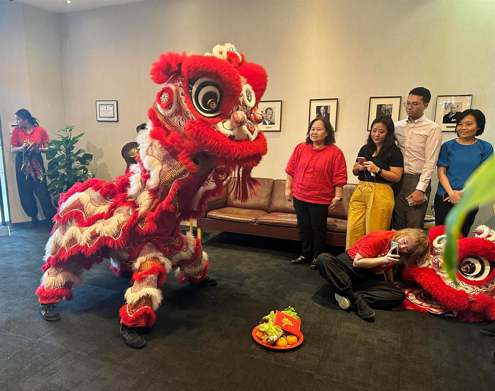 A traditional lion dance at the office in Singapore