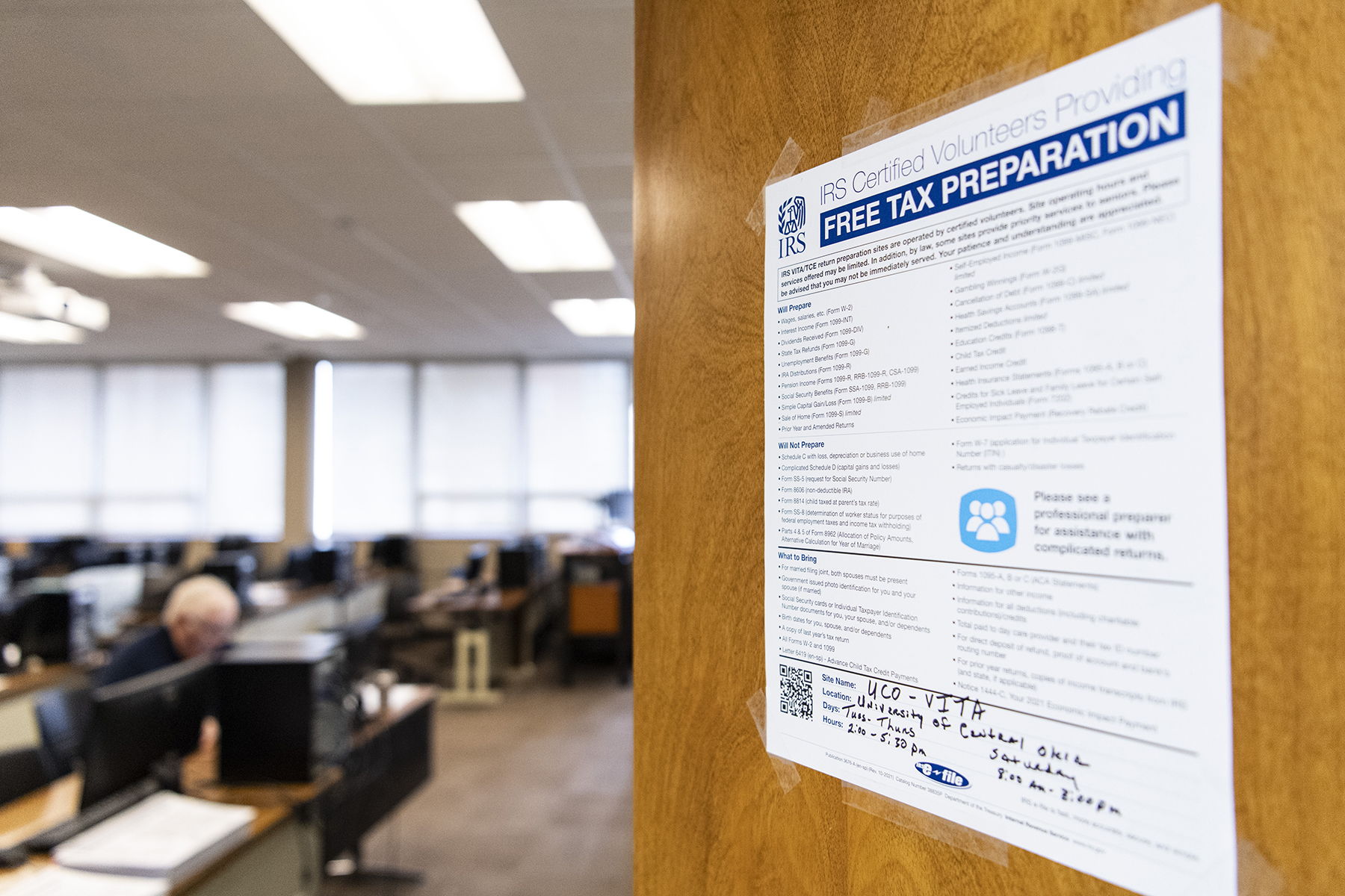 Door leading into a classroom with a sign about income taxes