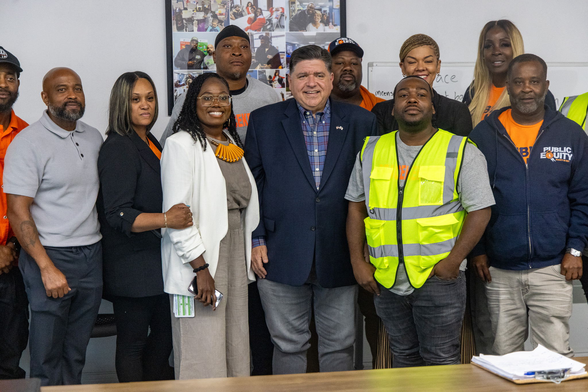 Gov. Pritzker smiles with the team from Public Equity in Englewood. (Office of the Governor)