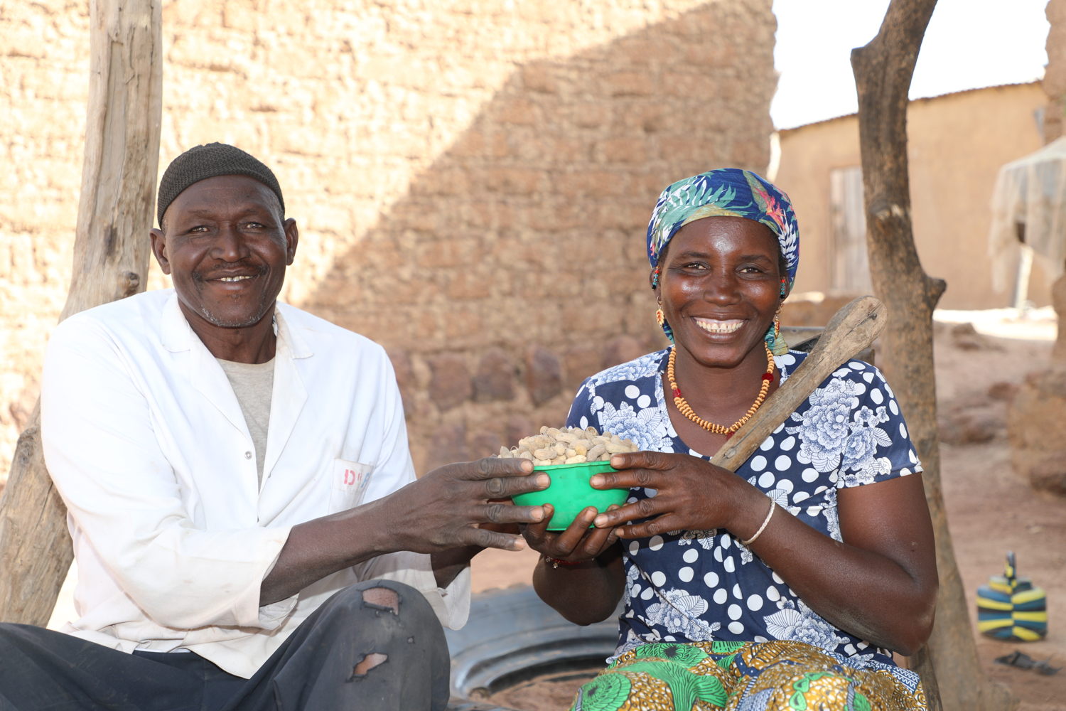 Happy farmers show a sample of their groundnut harvest.