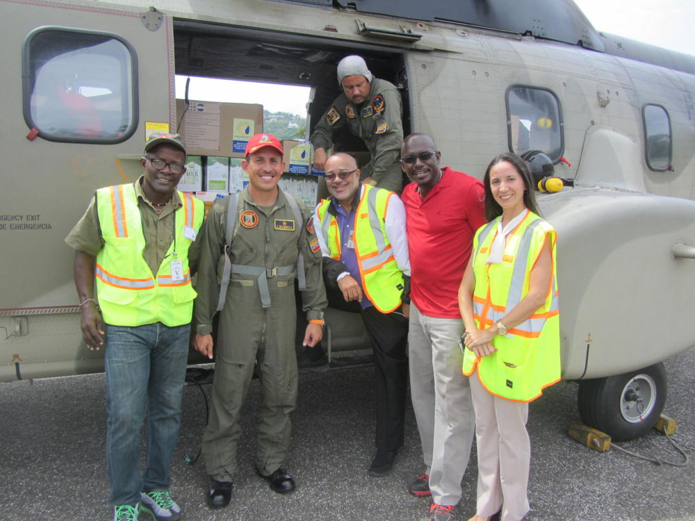 A Venezuelan Helicopter drop prepares to leave: (L to R): Former Non-Resident Ambassador to Petro-Caribe and ALBA, Eustace Vitalis, Venezuelan Flight Operations Manager, OECS Director General, H.E Dr. Didacus Jules, Grenada's Ambassador to the OECS H.E Dr. Patrick Antoine and Venezuela's Ambassador H.E Leiff Escalona. 