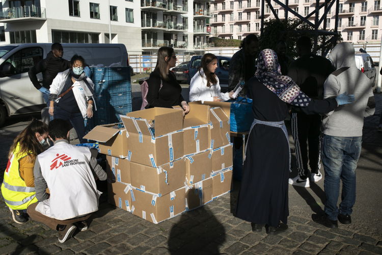 Ongeveer 300 mensen met sociale uitsluiting (inclusief daklozen, migranten en asielzoekers) helpen bij de distributie van voedsel- en hygiënekits die worden ondersteund door AZG, het Rode Kruis en de burgerplatforms © Albert Masias