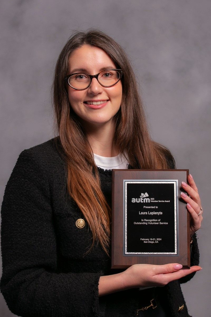 Laura Lapienyte holding her AUTM Volunteer Service Award