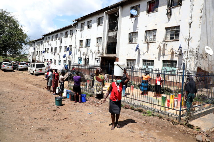 Residents of the suburb of Mbare, in Zimbabwe's capital city of Harare collect water from a water point. The water point is one of many in the city connected to a newly drilled or rehabilitated boreholes providing residents with easy access to clean and reliable water sources. Photographer. Dorothy Meck