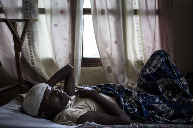 Myime Richards (32), recovers in a hospital room on 2 March 2018 in Bunia. He lost his wife, three of his four children and suffered servere lacerations to his head and neck after an attack on his village. ©John Wessels/MSF Myime Richards (32), recovers in a hospital room on 2 March 2018 in Bunia. He lost his wife, three of his four children and suffered servere lacerations to his head and neck after an attack on his village. ©John Wessels/MSF