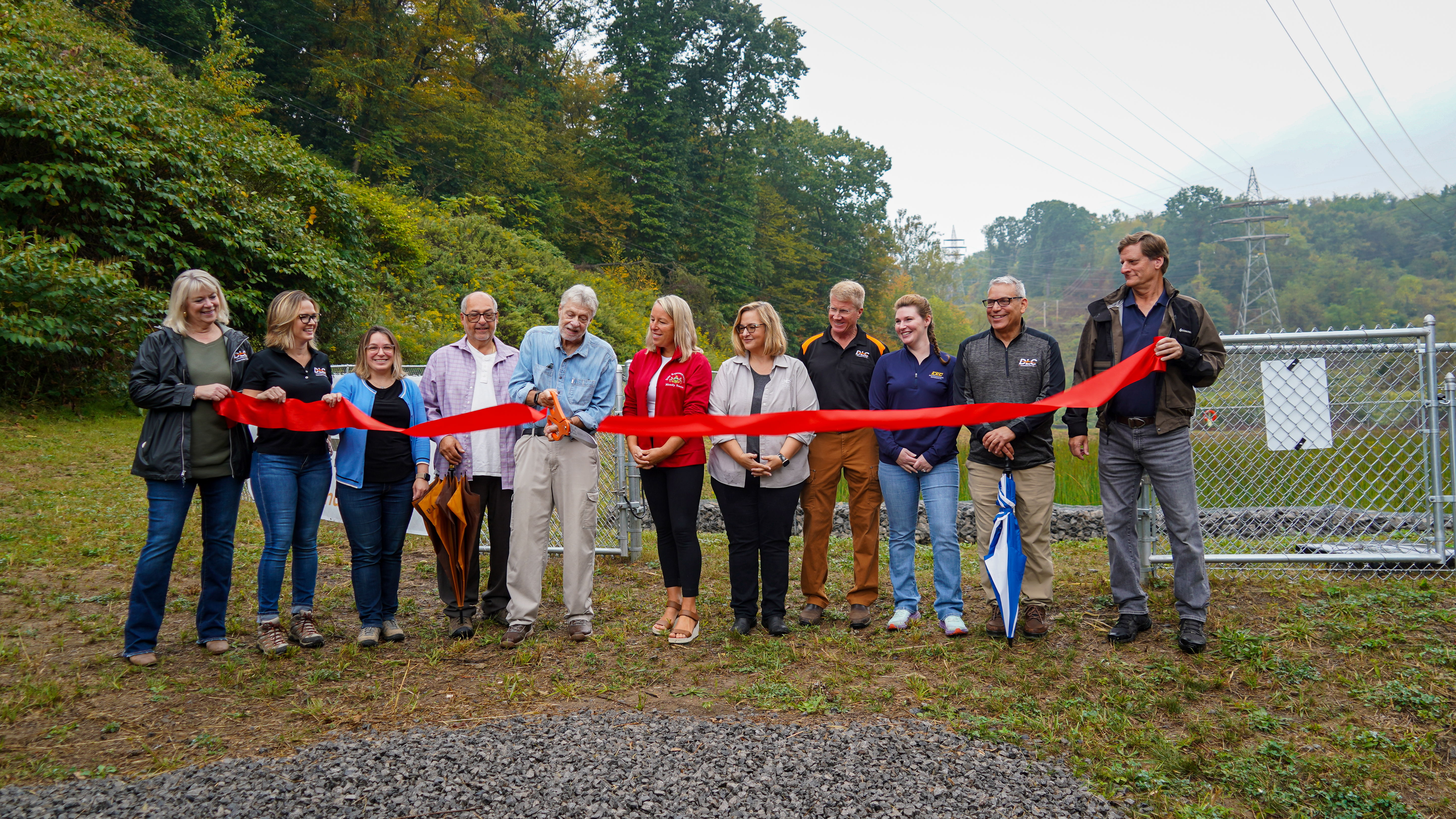 Local and state officials and DLC personnel celebrate the opening of the wetland