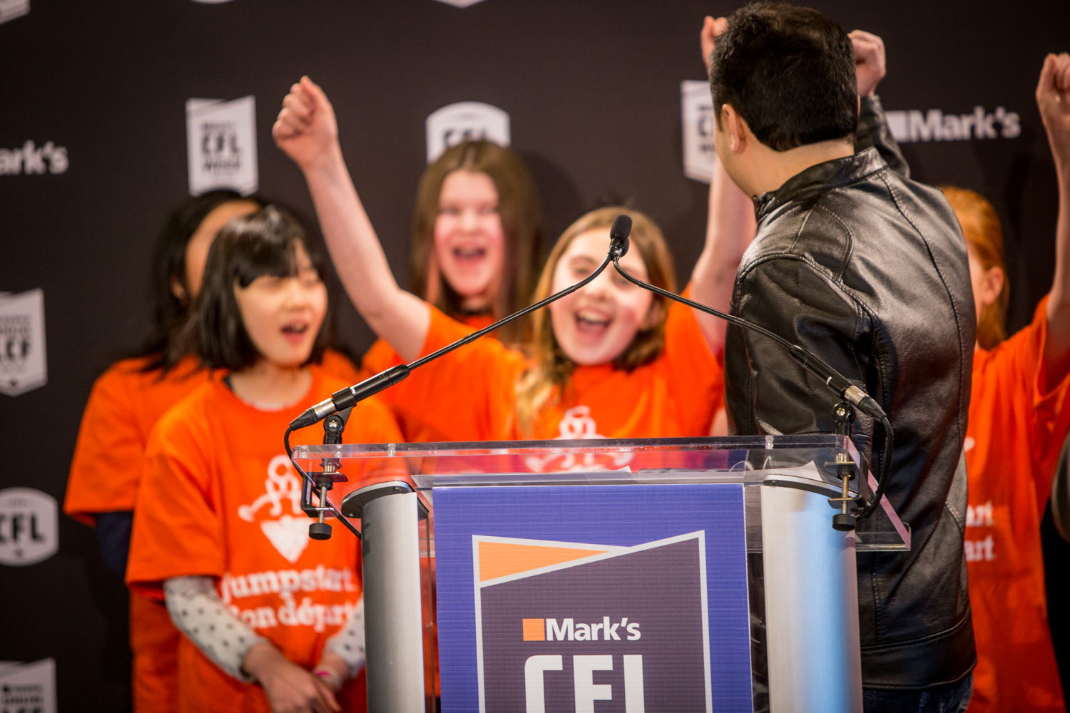 David Lui, Vice-President of Marketing at Mark's, with Jumpstart kids at the event. Photo credit: Reid Valmestad/CFL 