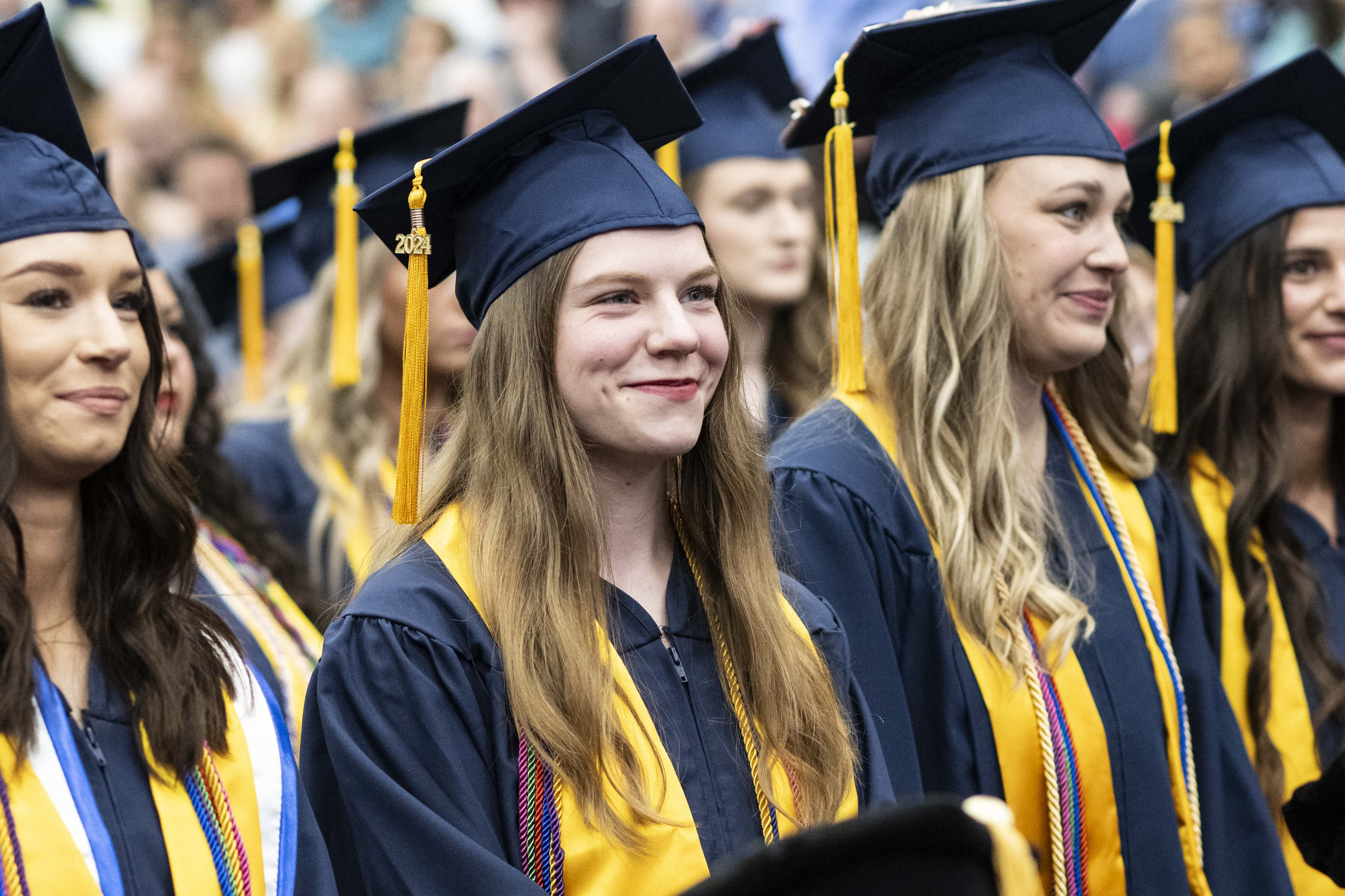A group of UCO graduates standing during a prior year ceremony. A group of UCO graduates standing during a prior year ceremony.