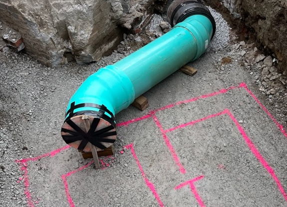 Inside the work zone at Sixth Avenue and Diamond Street where new 15-inch drainage pipe is being installed with a pink outline depicting where the new catch basin will be placed