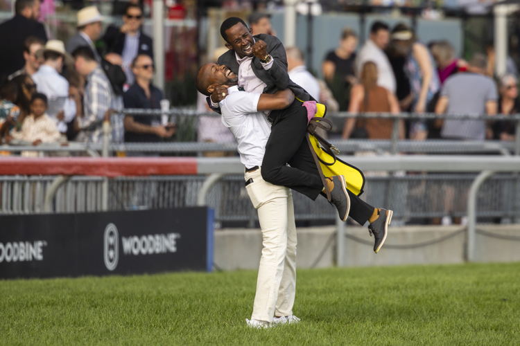 Troy Garnett and exercise rider Jalon Samuels after Caitlinhergrtness won The King's Plate (Michael Burns Photo)