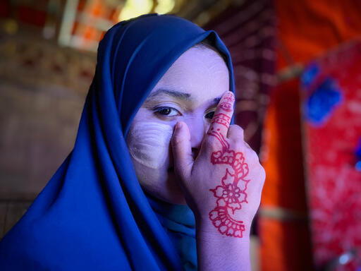 Ayesha, 12, poses with tanaka, a traditional cosmetic, on her face. Cox’s Bazar, Bangladesh, October 2023 © Ishrat Bibi