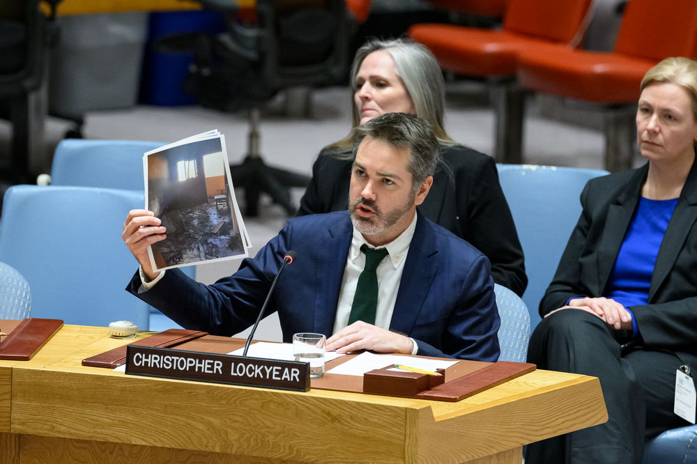 Christopher Lockyear, secretary general of Médecins Sans Frontières (MSF), holds up an image of the destroyed MSF shelter in Al-Mawasi in Khan Younis, Gaza. An MSF staff member’s wife and daughter-in-law were killed and six other people were injured when an Israeli tank fired on a clearly marked MSF staff shelter on February 20, 2024. Lockyear called on the United Nations Security Council (UNSC) to demand an immediate and sustained ceasefire in Gaza. Addressing the Council at its monthly meeting on Gaza, Lockyear also called for the unequivocal protection of medical facilities, staff, and patients. | Date taken: 22/02/2024 | Photographer: UN Photo/Loey Filipe | Location: Palestinian Territories