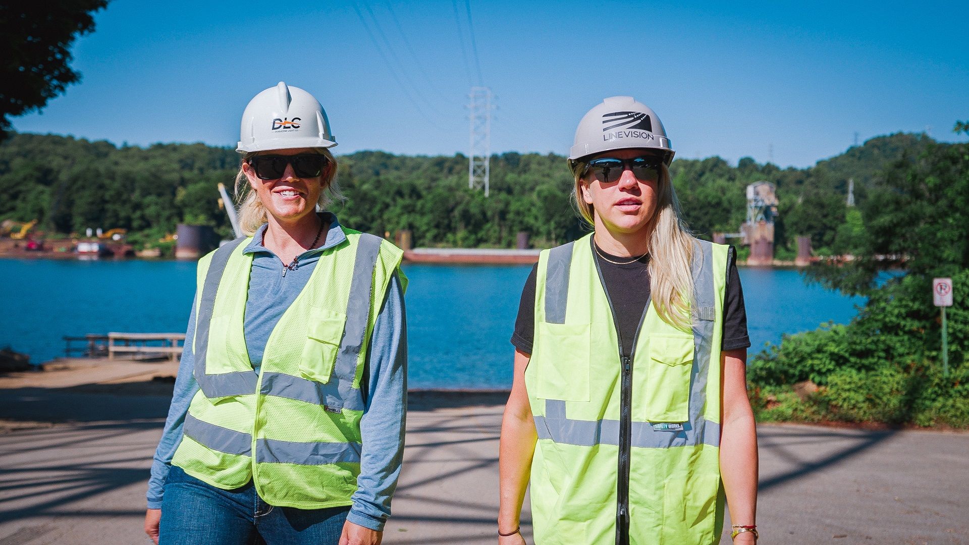Dr. Elizabeth Cook, DLC's general manager of advanced grid solutions (left), and Tiffany Menhorn, senior director of LineVision, watching crews install sensors for the dynamic line rating project.
