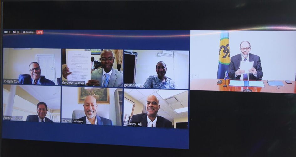 CARICOM SG and the CPSO Chairman showing their signed copies during the online ceremony.