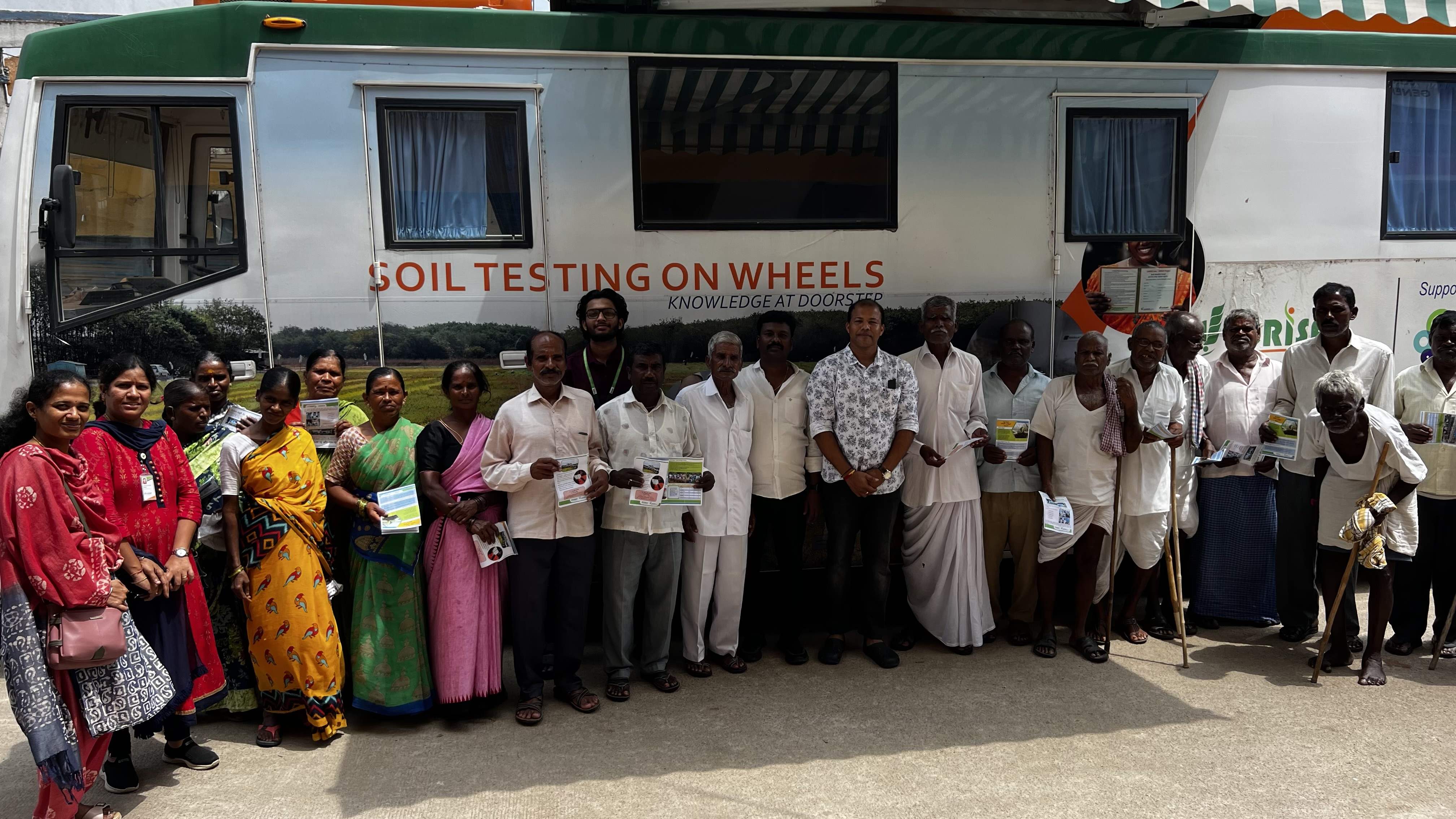 Farmers pose with their soil health cards in front of the Mobile Soil Lab – Technology on Wheels. Farmers pose with their soil health cards in front of the Mobile Soil Lab – Technology on Wheels.