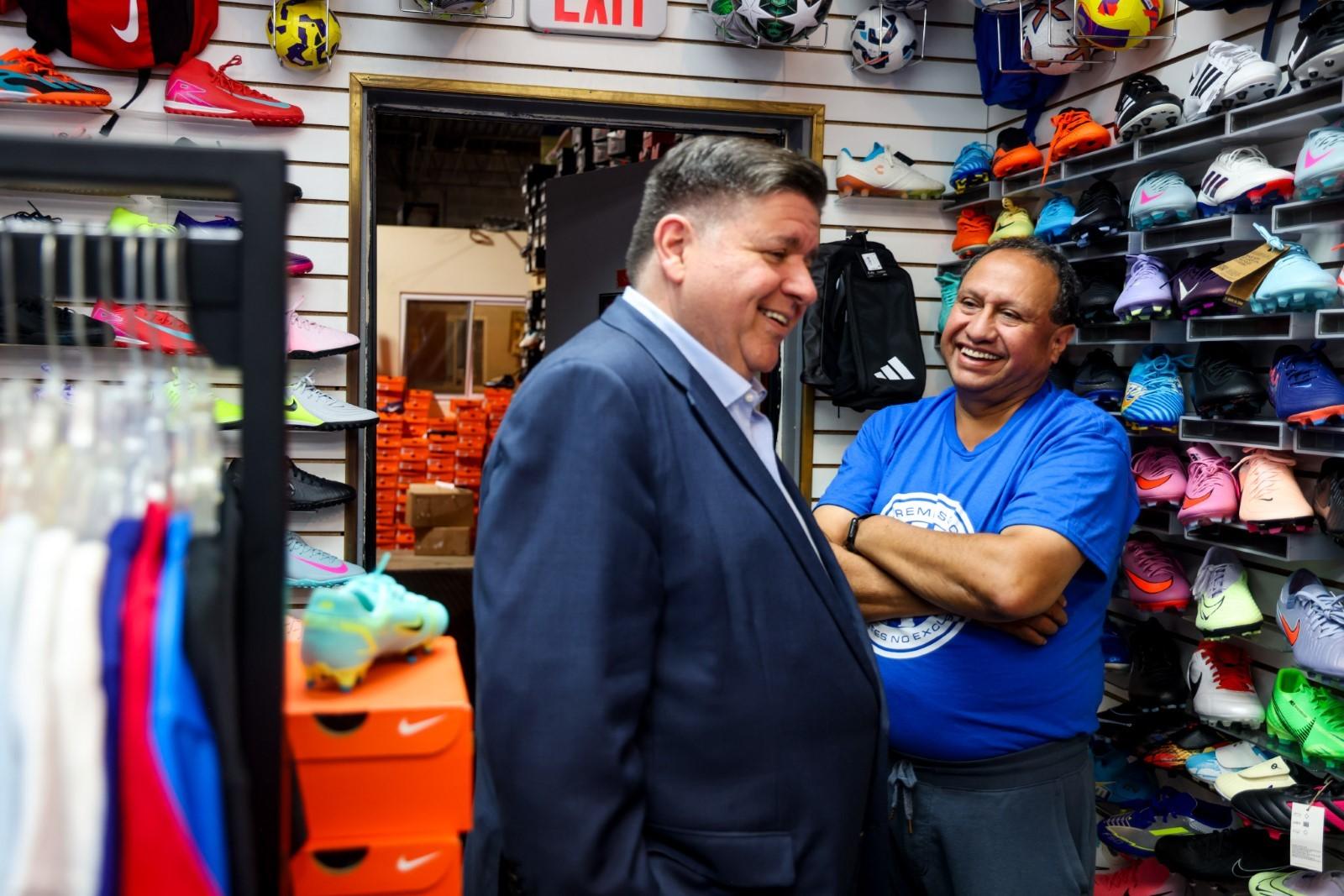 Gov. Pritzker browses the selection of soccer cleats with Miguel Tovar, owner and manager of Extreme Soccer in Berwyn. (Office of the Governor)