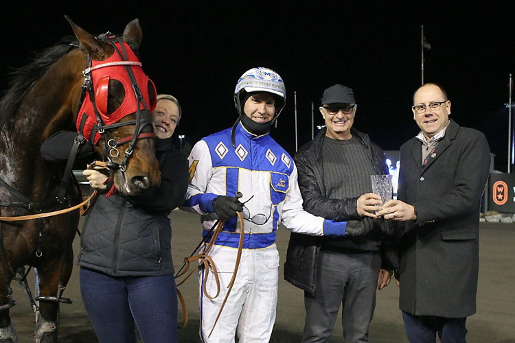 Nautical Hanover receives the New Holland Pacing Series trophy. (New Image Media)