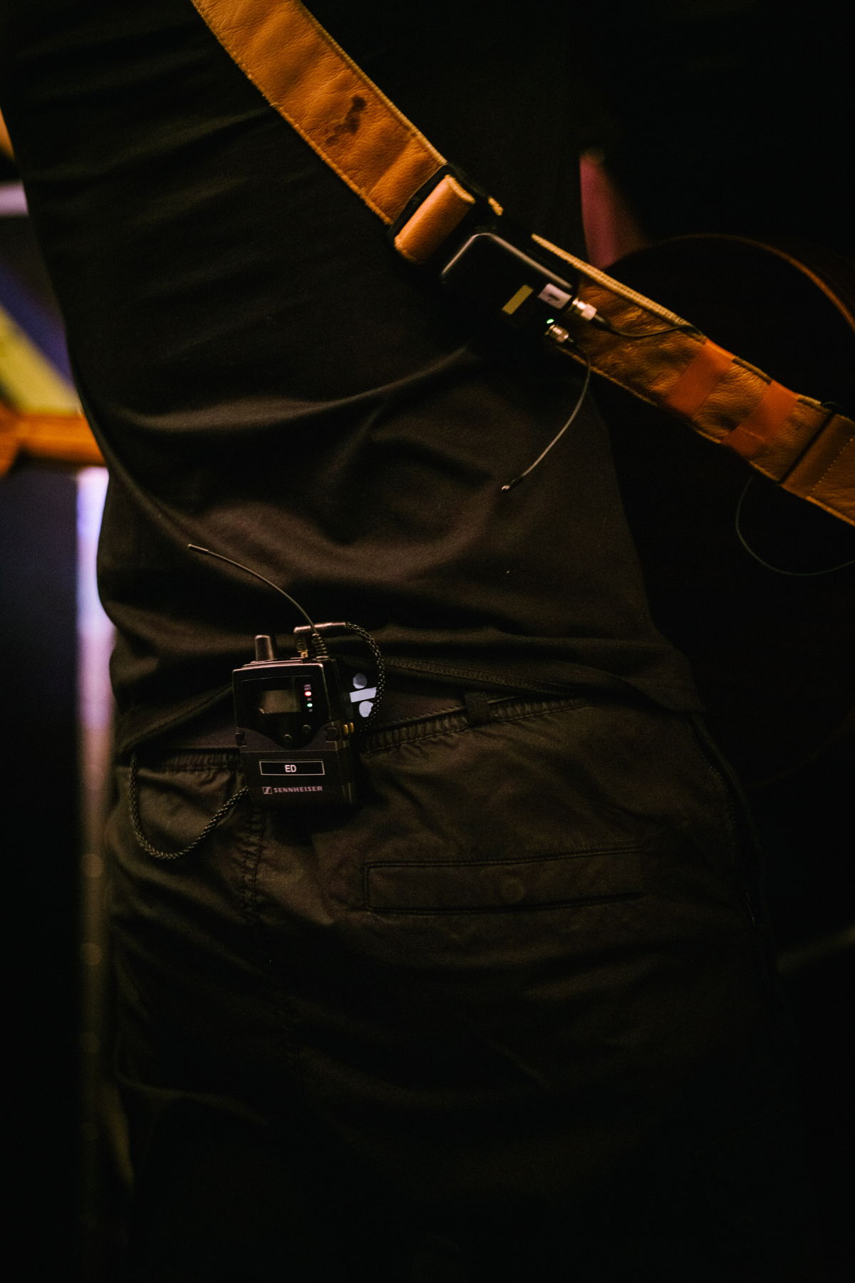 The SK 6212 mini-transmitter is attached to the guitar strap.  Photo credit: Zak Walters