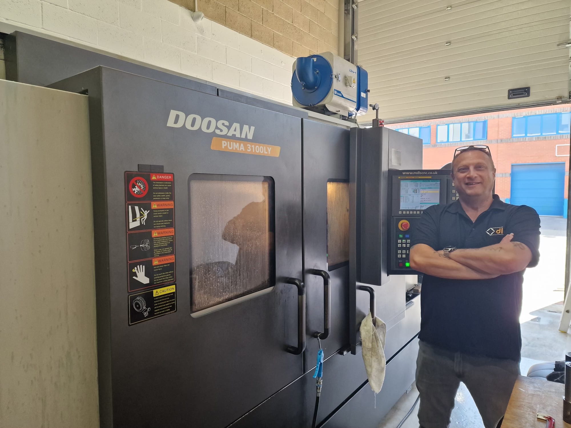 DLM’s latest recruit, Gary Owen, CNC turner, alongside a newly acquired lathe. DLM’s latest recruit, Gary Owen, CNC turner, alongside a newly acquired lathe.
