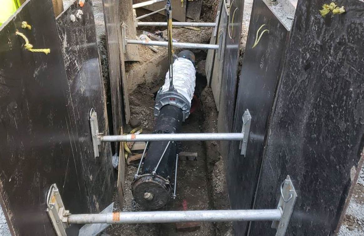 12-inch ductile iron water main being installed with a protective barrier at Sixth Avenue and Wood Street 12-inch ductile iron water main being installed with a protective barrier at Sixth Avenue and Wood Street