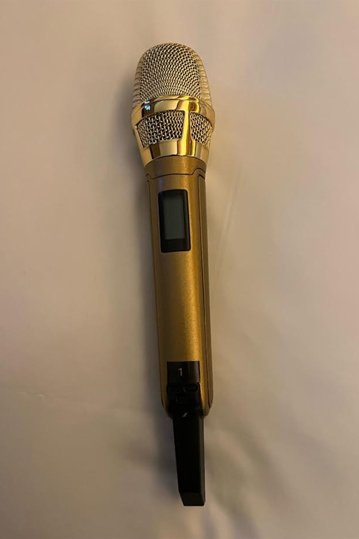 Brandi Carlile’s Sennheiser SKM 6000 handheld transmitter with Neumann KK 205 microphone capsule, plated in gold ​ ​ (Photo by Sean Quackenbush)