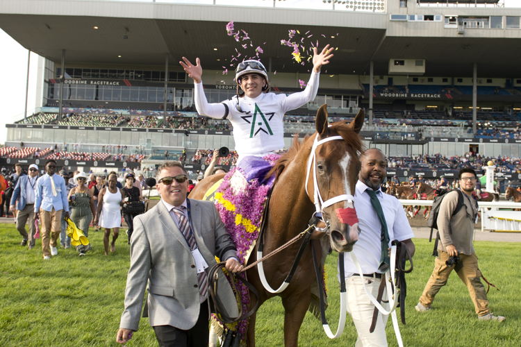 Caitlinhergrtness, trainer Kevin Attard, and jockey Rafael Hernandez walking to the Woodbine Winner's Circle after winning The 165th King's Plate (Michael Burns Photo) 