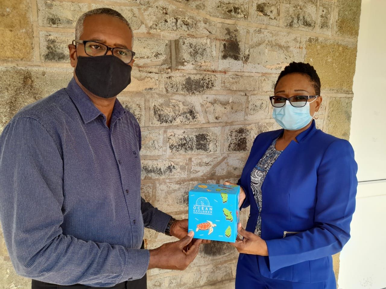 David Robin of OECS presents hard copy of Ocean Explorer game to PS Michelle Charles
