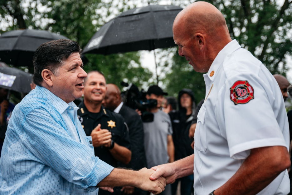 Governor Pritzker meets with community members, local officials, and first responders in Lansing, including Lansing Fire Chief Chad Kooyenga.