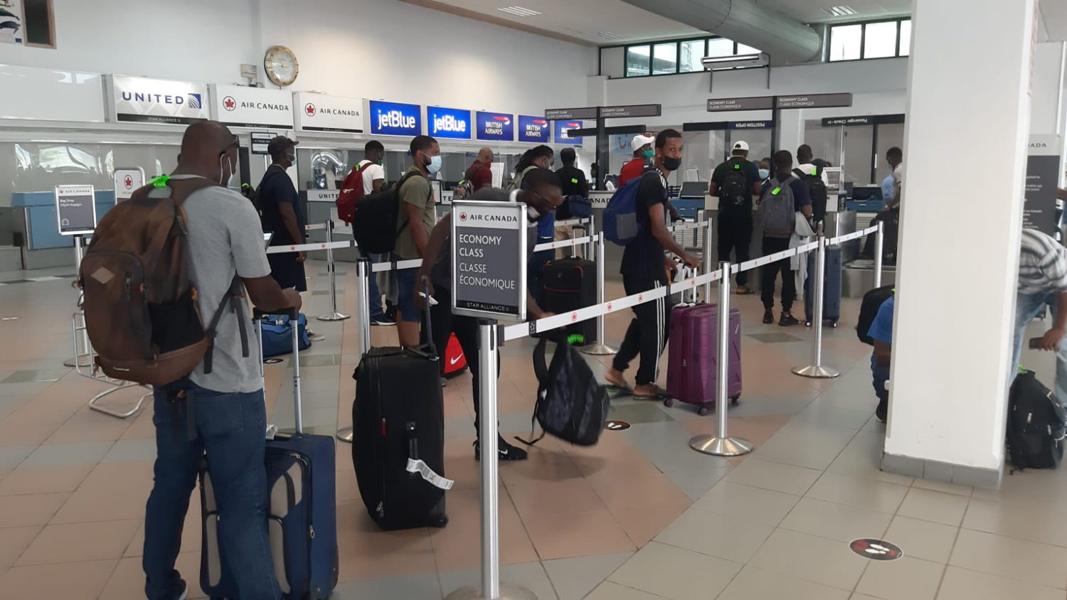 Farm workers from the OECS prepare for departure to Canada.